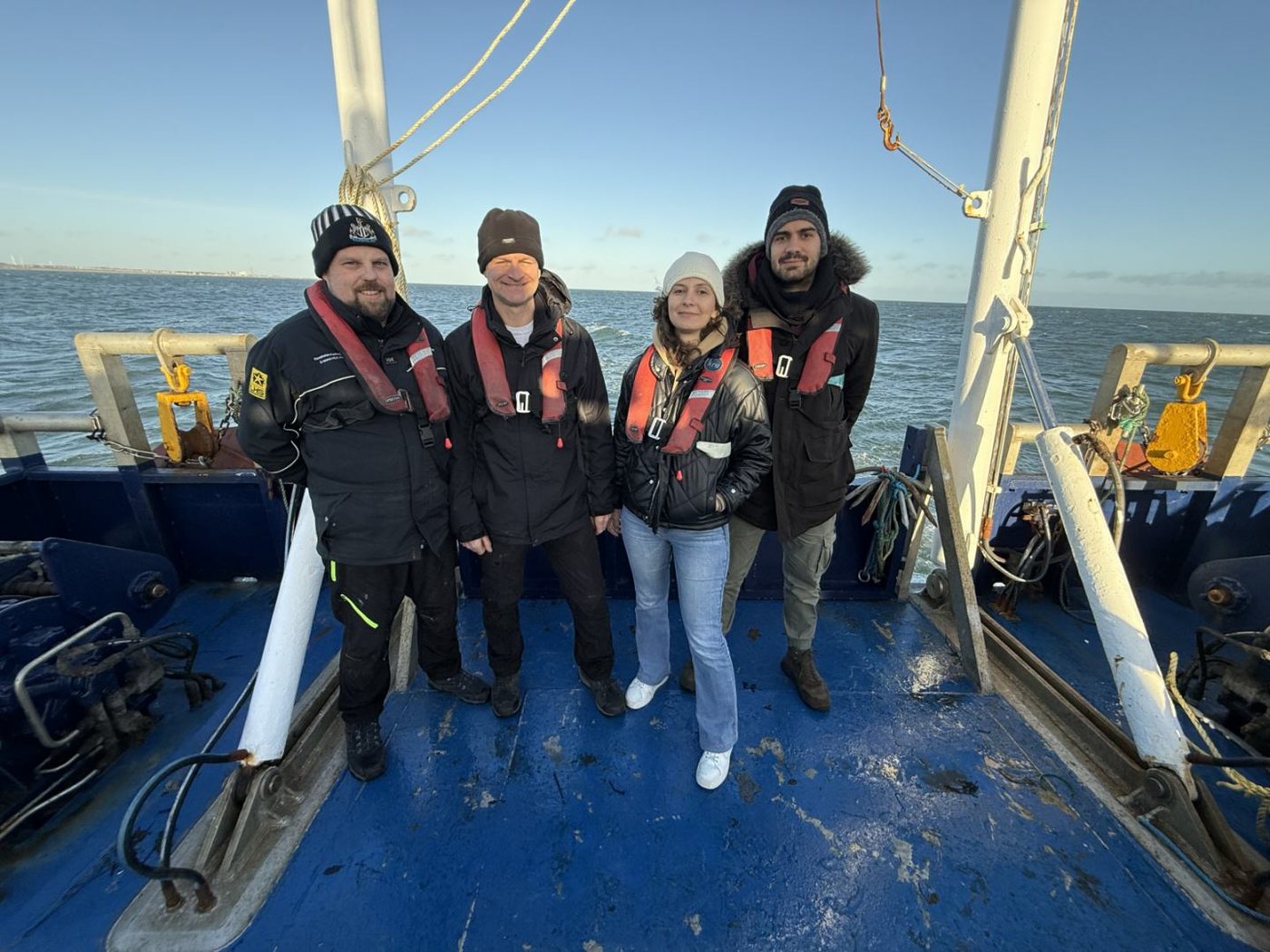 Research team on the deck of a survey vessel during sea trials