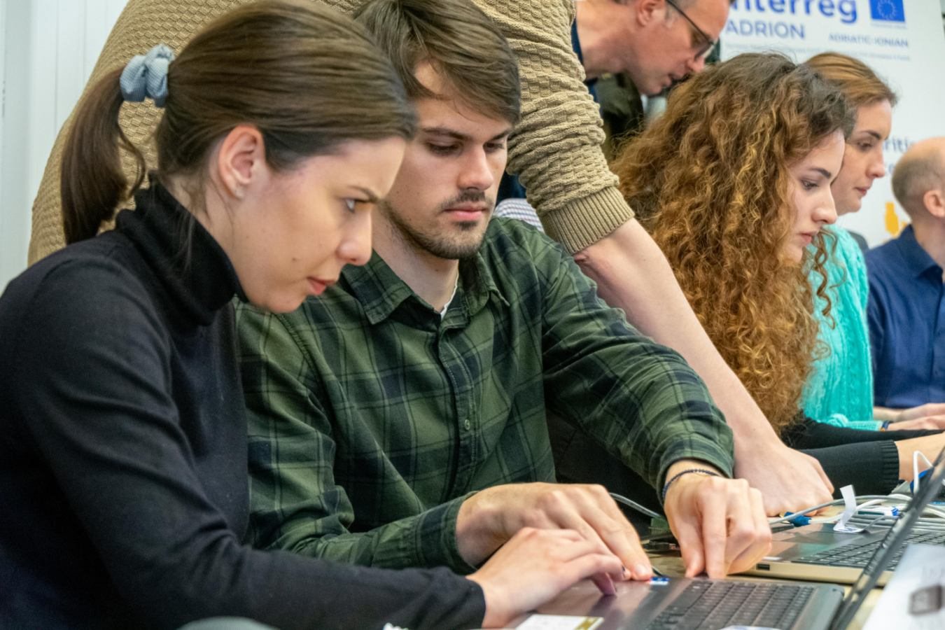 Workshop participants working through an exercise on their laptops